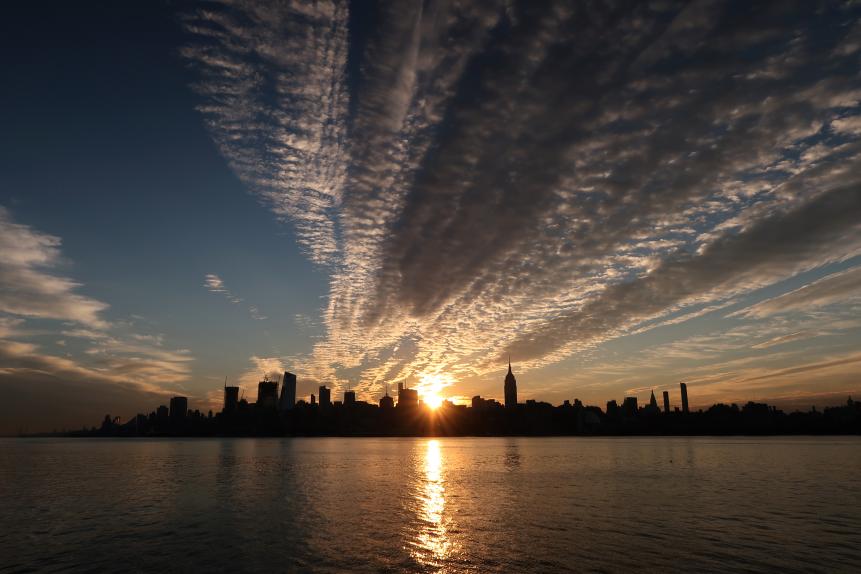 HOBOKEN, NJ - JUNE 21: The sun rises behind the skyline of midtown Manhattan and the Empire State Building on the summer solstice in New York City on June 21, 2017 as seen from Hoboken, NJ. (Photo by Gary Hershorn/Getty Images)