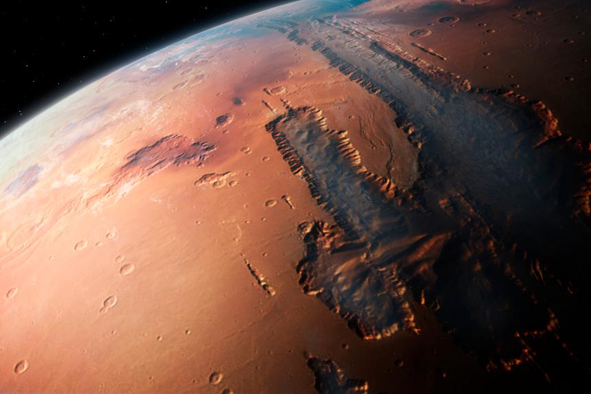 Illustration of an oblique view of the giant Valles Marineris canyon system on Mars. The Valles Marineris is over 3000 km long and up to 8 km deep, dwarfing the Grand Canyon of Arizona. The canyons were formed by a combination of geological faulting, landslides, and erosion by wind and ancient water flows. The view is looking west, from an altitude of about 2000 km, and shows the canyon filled with low-altitude fog and cloud.