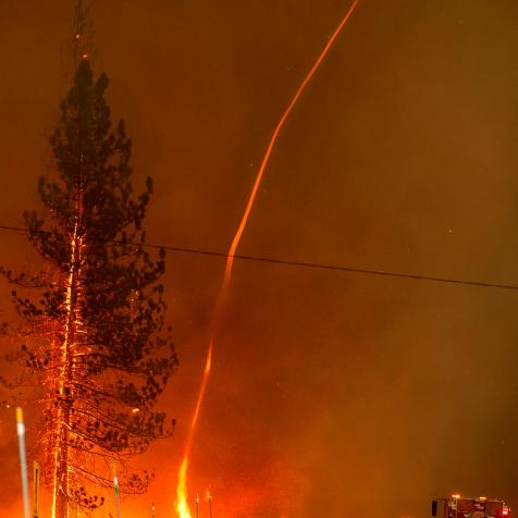 A fire whirl shoots into the sky as flames from the Hog fire jump highway 36 about 5 miles from Susanville, California on July 20, 2020. - The fire exploded to more than 6,000 acres and created its own weather, generating lightning, thunder, rain and fire whirls out of a huge pyrocumulonimbus ash plume towering above. The 
Lassen County Sheriff's office issued a mandatory evacuation order for the area. (Photo by JOSH EDELSON / AFP) (Photo by JOSH EDELSON/AFP via Getty Images)