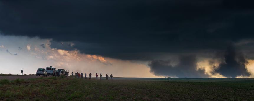 These two spectacular sister tornadoes tore up farmland for over half an hour. Taken on the High Plains of Colorado in May. Seen here with a group of storm chasers enjoying the spectacle.