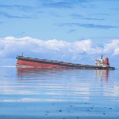 This general view taken on August 7, 2020, shows the vessel MV Wakashio, belonging to a Japanese company but Panamanian-flagged, that ran aground near Blue Bay Marine Park off the coast of south-east Mauritius. - France on August 8, 2020 dispatched aircraft and technical advisers from Reunion to Mauritius after the prime minister appealed for urgent assistance to contain a worsening oil spill polluting the island nation's famed reefs, lagoons and oceans. Rough seas have hampered efforts to stop fuel leaking from the bulk carrier MV Wakashio, which ran aground two weeks ago, and is staining pristine waters in an ecologically protected marine area off the south-east coast. (Photo by Daren Mauree / L'Express Maurice / AFP) (Photo by DAREN MAUREE/L'Express Maurice/AFP via Getty Images)