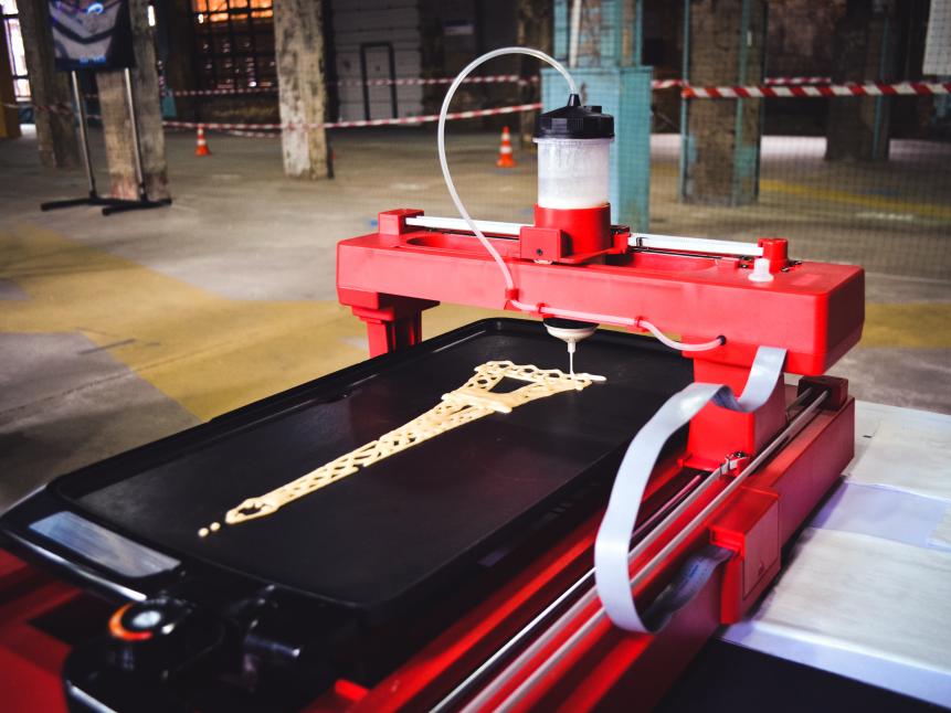 3d printer that printing a liquid dough. 3D printer printing pancakes with liquid dough different shapes close-up. Modern additive technologies 4.0 industrial revolution