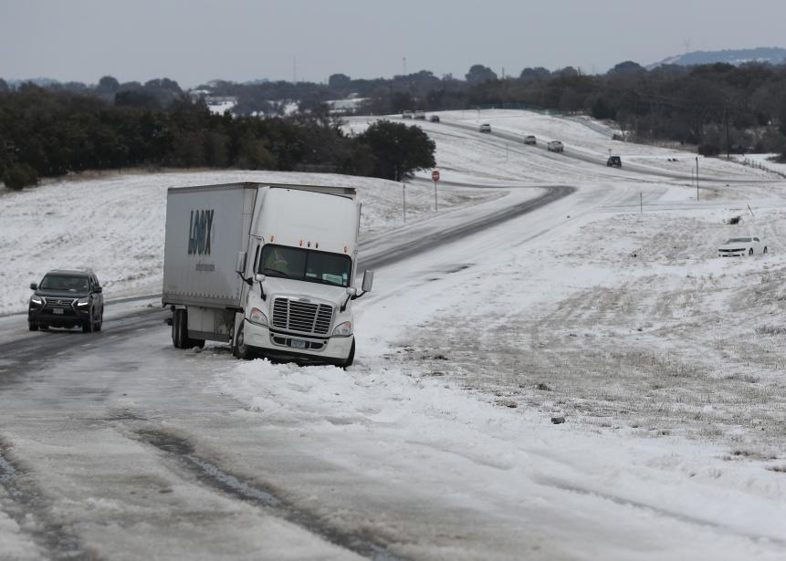 KILLEEN, TEXAS - FEBRUARY 18: A tractor trailer is stuck in the slick ice and snow on State Highway 195 on February 18, 2021 in Killeen, Texas. Winter storm Uri has brought historic cold weather and power outages to Texas as storms have swept across 26 states with a mix of freezing temperatures and precipitation. (Photo by Joe Raedle/Getty Images)