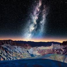 Please consider this image for Prestige Rights Managed. A VERY difficult shot to obtain.The Milky Way over Zabriskie Point with Panamint Range glowing in distance, Mojave Desert.