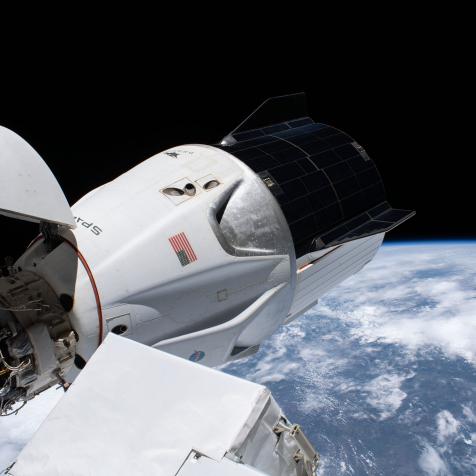 The SpaceX Crew Dragon spacecraft, with its nose cone open, is pictured docked to the Harmony module's forward international docking adapter. The International Space Station was orbiting 264 miles above southern Brazil when this photograph was taken.