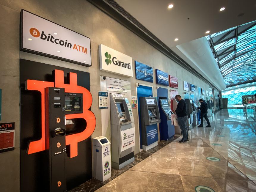 ISTANBUL, TURKEY - APRIL 16: People use bank ATM"s next to a Bitcoin ATM machine at a shopping mall on April 16, 2021 in Istanbul, Turkey. Turkey's Central Bank announced a ban on the use of cryptocurrencies and crypto assets for purchases, directly or indirectly to pay for goods or services. The announcement comes as Turkey's crypto market has boomed over the past few years. As the Turkish Lira has slumped, many people have looked to cryptocurrencies to shelter against inflation. Cryptocurrencies gained traction globally this week after cryptocurrency exchange Coinbase launched on the New York Stock Exchange. (Photo by Chris McGrath/Getty Images)