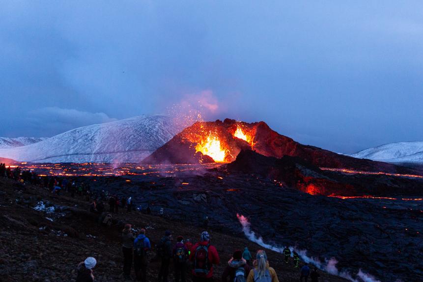 REYKJANES PENINSULA, ICELAND - MARCH 28: People gather on the hillside to watch the volcano erupt as the sun sets on March 28, 2021 on the Reykjanes Peninsula, Iceland. The Mount Fagradalsfjall volcano erupted on March 19, after thousands of small earthquakes in the area over the recent weeks, and was reportedly the first eruption of its kind on the Reykjanes Peninsula in around 800 years. (Photo by Sophia Groves/Getty Images)