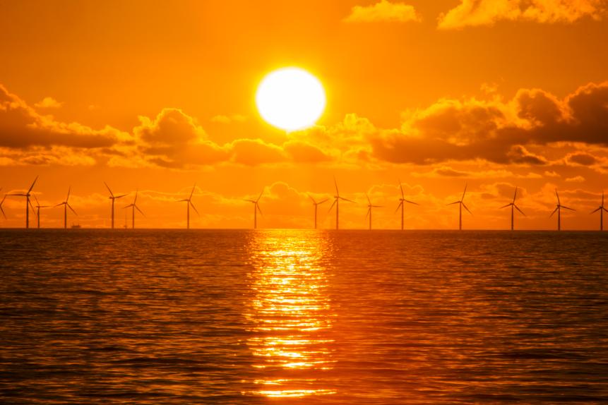 Sunset over the Walney offshore Wind farm from Walney island showing both the wind turbines and a gas platform further out in Morecambe Bay. The windfarm will shortly be the largest offshore wind farm in the world and currently generates 367 MW.