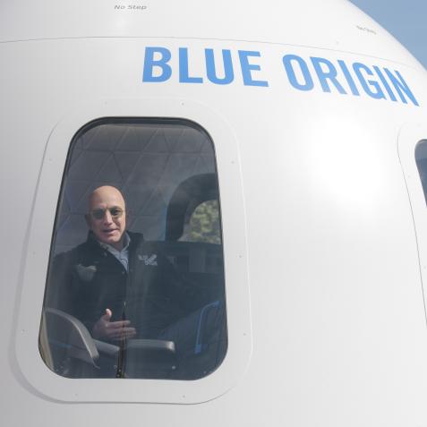 Jeff Bezos, chief executive officer of Amazon.com Inc. and founder of Blue Origin LLC, sits inside the high fidelity crew capsule mock up of the Blue Origin New Shepard system during the Space Symposium in Colorado Springs, Colorado, U.S., on Wednesday, April 5, 2017. Bezos has been reinvesting money he made at Amazon since he started his space exploration company more than a decade ago, and has plans to launch paying tourists into space within two years. Photographer: Matthew Staver/Bloomberg via Getty Images