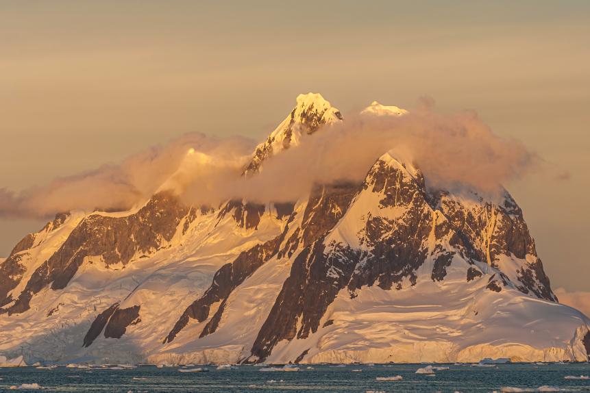 Mountains and glaciers,  near Petermann Island, Antarctic Peninsula, Antarctica at sunset with snow, glaciers and ocean .