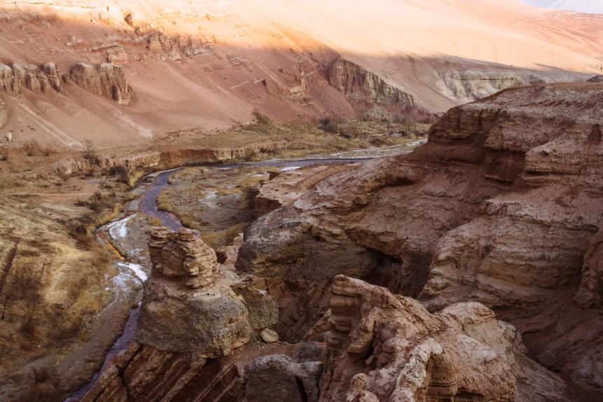 Turpan, Xinjiang, China : A stream of water meanders through a gorge in the Flaming Mountains near the northern rim of the Taklamakan Desert.