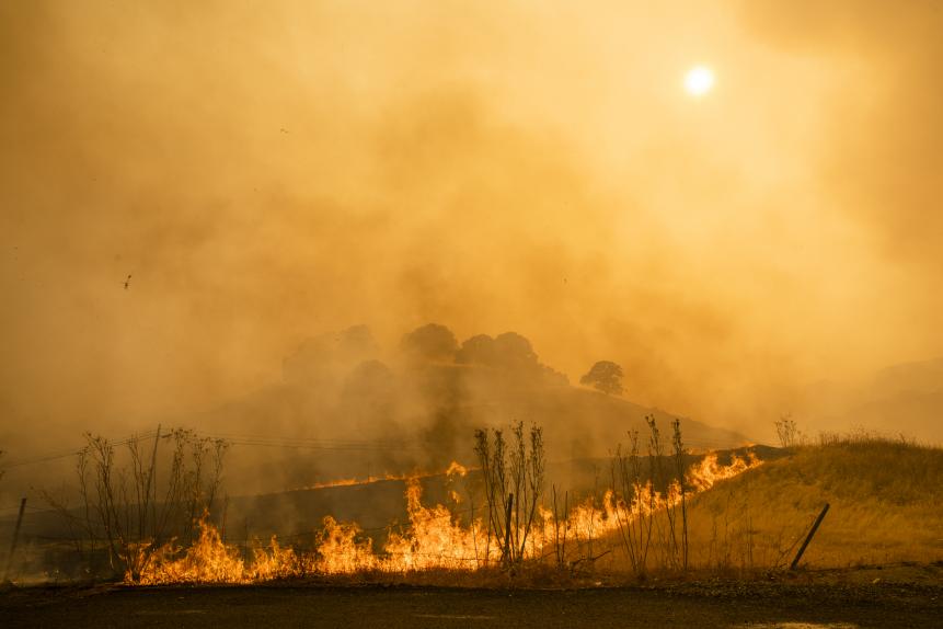 Flames and smoke from wildfires cover the landscape in California, U.S. Photographer: Philip Pacheco/Bloomberg