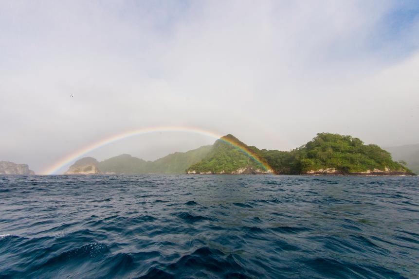 Cocos island shot with a local rainbow after some light rain. This image was taken from a boat after a dive.