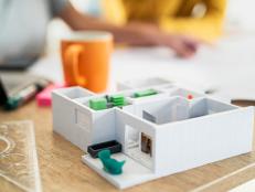 Close-up of architectural model in desk while female architects working on background