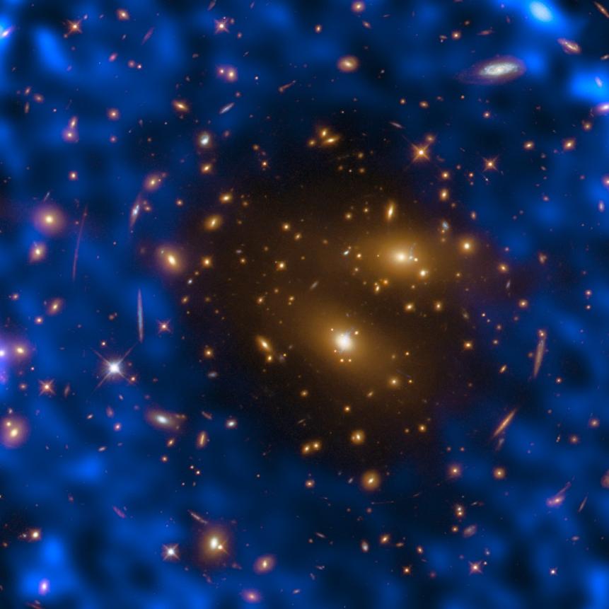 The events surrounding the Big Bang were so cataclysmic that they left an indelible imprint on the fabric of the cosmos. We can detect these scars today by observing the oldest light in the Universe. As it was created nearly 14 billion years ago, this light — which exists now as weak microwave radiation and is thus named the cosmic microwave background (CMB) — has now expanded to permeate the entire cosmos, filling it with detectable photons. The CMB can be used to probe the cosmos via something known as the Sunyaev-Zel’dovich (SZ) effect, which was first observed over 30 years ago. We detect the CMB here on Earth when its constituent microwave photons travel to us through space. On their journey to us, they can pass through galaxy clusters that contain high-energy electrons. These electrons give the photons a tiny boost of energy. Detecting these boosted photons through our telescopes is challenging but important — they can help astronomers to understand some of the fundamental properties of the Universe, such as the location and distribution of dense galaxy clusters. The NASA/ESA Hubble Space Telescope observed one of most massive known galaxy clusters, RX J1347.5–1145, seen in this Picture of the Week, as part of the Cluster Lensing And Supernova survey with Hubble (CLASH). This observation of the cluster, 5 billion light-years from Earth, helped the  Atacama Large Millimeter/submillimeter Array (ALMA) in Chile to study the cosmic microwave background using the thermal Sunyaev-Zel’dovich effect. The observations made with ALMA are visible as the blue-purple hues. Links   ESO Picture of the Week  RX J1347.5–1145 seen by Hubble only