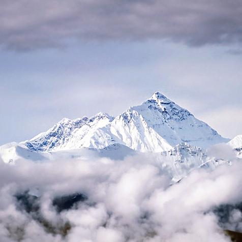 Peak of Mount Everest Above Clouds in Tibet.