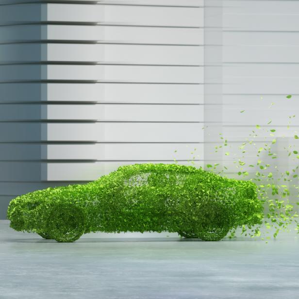 Digital generated image of generic car made out of green leaves in urban space.