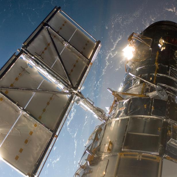 The Hubble Space Telescope in a picture snapped by a Servicing Mission 4 crewmember just after the Space Shuttle Atlantis captured Hubble with its robotic arm on May 13, 2009, beginning the mission to upgrade and repair the telescope.The Hubble Space Telescope is a project of international cooperation between NASA and the European Space Agency. NASA's Goddard Space Flight Center manages the telescope. The Space Telescope Science Institute conducts Hubble science operations.Goddard is responsible for HST project management, including mission and science operations, servicing missions, and all associated development activities.