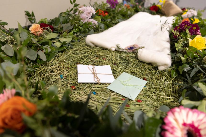 A demonstration "vessel" for the deceased, which has been decorated with flowers and compostable mementos by Return Home on top of a bed of straw, is pictured during a tour of the funeral home which specializes in human composting in Auburn, Washington on March 14, 2022. - Washington in 2019 became the first in the United States to make it a legal alternative to cremation. (Photo by Jason Redmond / AFP) (Photo by JASON REDMOND/AFP via Getty Images)
