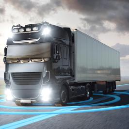 A moving truck on a highway. Blue graphics around the truck visualize an advanced driving technology.