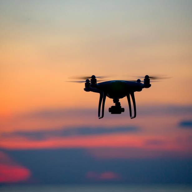 A drone flying in the sunset. 