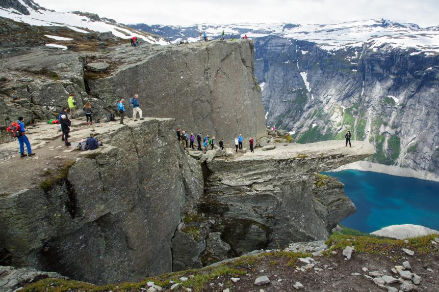 TYSSEDAL- NORWAY- JULY 8: Tourists queue up to take a picture on the rocky tip of the natural monument Trolltunga2015. ( Trolltunga ) in Hardangervidda close to Tyssedal in the province Hordaland in Norway on July 07, 2015. (Photo by Thomas Trutschel/Photothek via Getty Images)