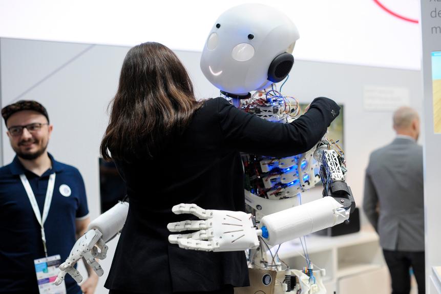 Congress attendant give a hug a Roboy 2.0 the only robot that imitates the human body structure, exhibited during the Mobile World Congress, on February 27, 2019 in Barcelona, Spain. 
 (Photo by Joan Cros/NurPhoto via Getty Images)
