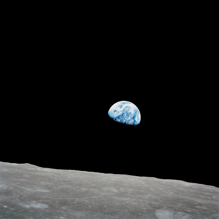 December 24, 1968 - The rising Earth is about five degrees above the lunar horizon in this telephoto view taken from the Apollo 8 spacecraft near 110 degrees east longitude. The horizon, about 570 kilometers (350 statute miles) from the spacecraft, is near the eastern limb of the moon as viewed from Earth. Width of the view at the horizon is about 150 kilometers (95 statute miles). On Earth 240,000 statute miles away the sunset terminator crosses Africa. The South Pole is in the white area near the left end of the terminator. North and South America are under the clouds.